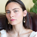 A pair of pearl drop earrings with hammered brass and oxidized sterling silver, featuring micro faceted rutilated quartz details.