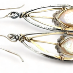 A pair of pearl drop earrings with hammered brass and oxidized sterling silver, featuring micro faceted rutilated quartz details.