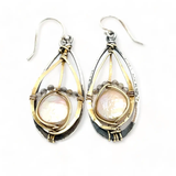 A pair of pearl drop earrings with hammered brass and oxidized sterling silver, featuring micro faceted rutilated quartz details.