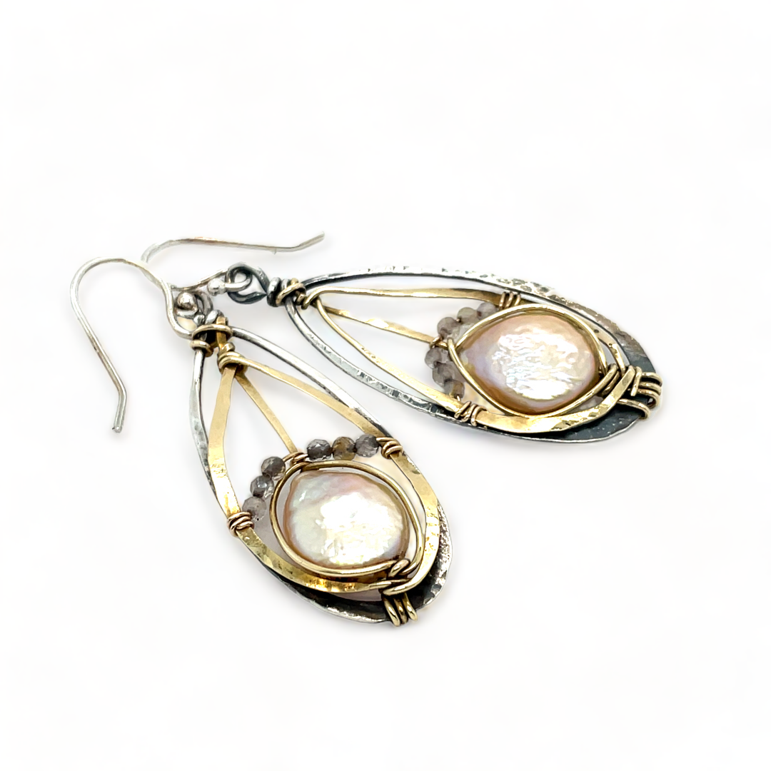 A pair of pearl drop earrings with hammered brass and oxidized sterling silver, featuring micro faceted rutilated quartz details.