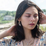 Leaf stamped brass semi circle earrings with sterling silver and gold filled wire details, featuring rose quartz, pink tourmaline, pink opal, and a pink fresh water pearl with built in earring hooks that wear like a post earring