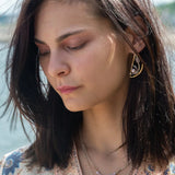 Leaf stamped brass semi circle earrings with sterling silver and gold filled wire details, featuring rose quartz, pink tourmaline, pink opal, and a pink fresh water pearl with built in earring hooks that wear like a post earring