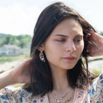 Leaf stamped brass semi circle earrings with sterling silver and gold filled wire details, featuring rose quartz, pink tourmaline, pink opal, and a pink fresh water pearl with built in earring hooks that wear like a post earring