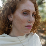 Sterling silver handmade mini earrings woven with gold filled wire hanging from a braided gold filled link