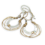 Sterling silver handmade mini earrings woven with gold filled wire hanging from a braided gold filled link