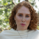 Sterling silver handmade mini earrings woven with gold filled wire hanging from a braided gold filled link