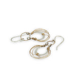Sterling silver handmade mini earrings woven with gold filled wire hanging from a braided gold filled link