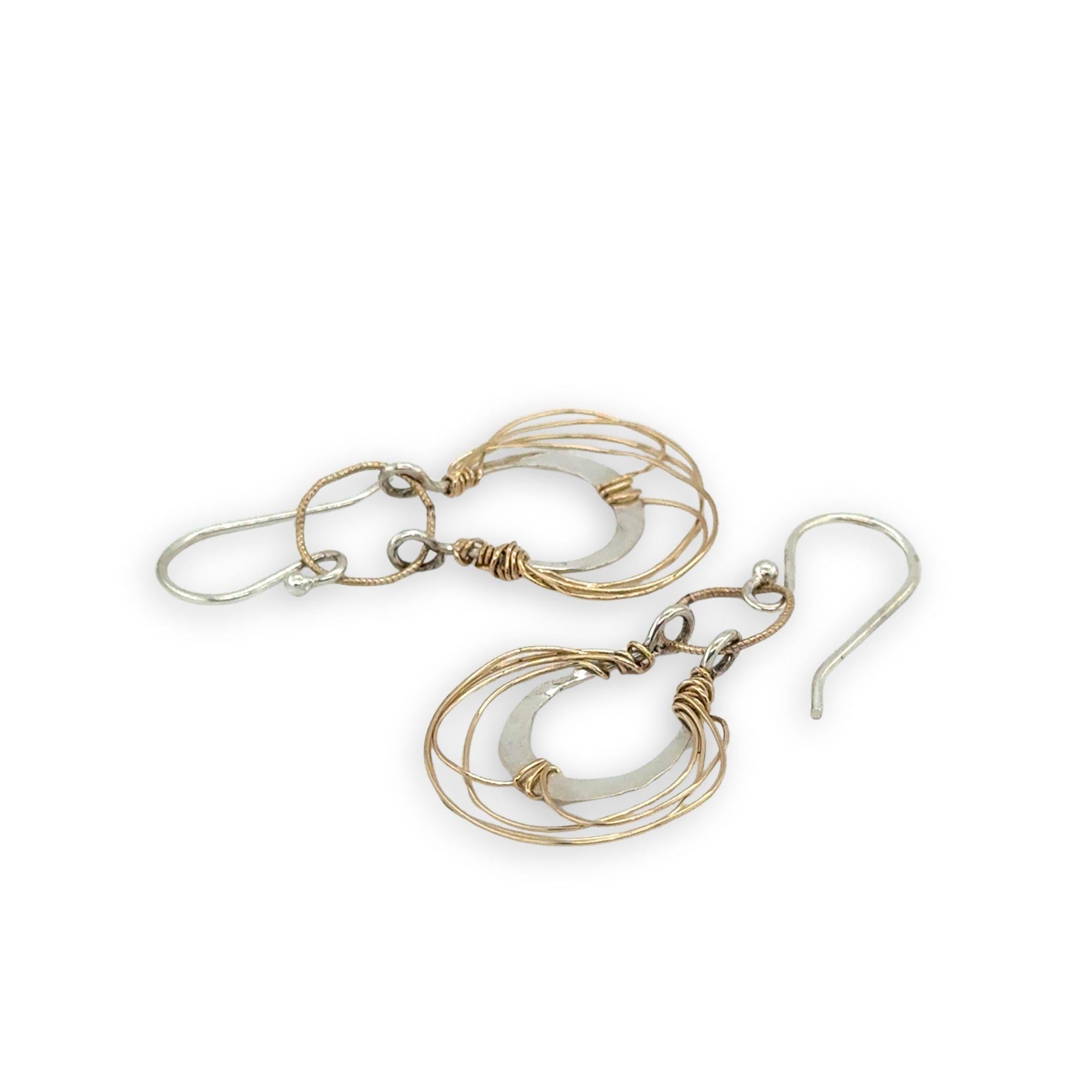 Sterling silver handmade mini earrings woven with gold filled wire hanging from a braided gold filled link
