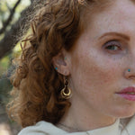 Sterling silver handmade mini earrings woven with gold filled wire hanging from a braided gold filled link