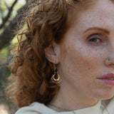 Sterling silver handmade mini earrings woven with gold filled wire hanging from a braided gold filled link