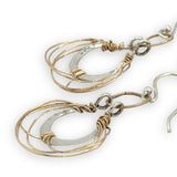 Sterling silver handmade mini earrings woven with gold filled wire hanging from a braided gold filled link
