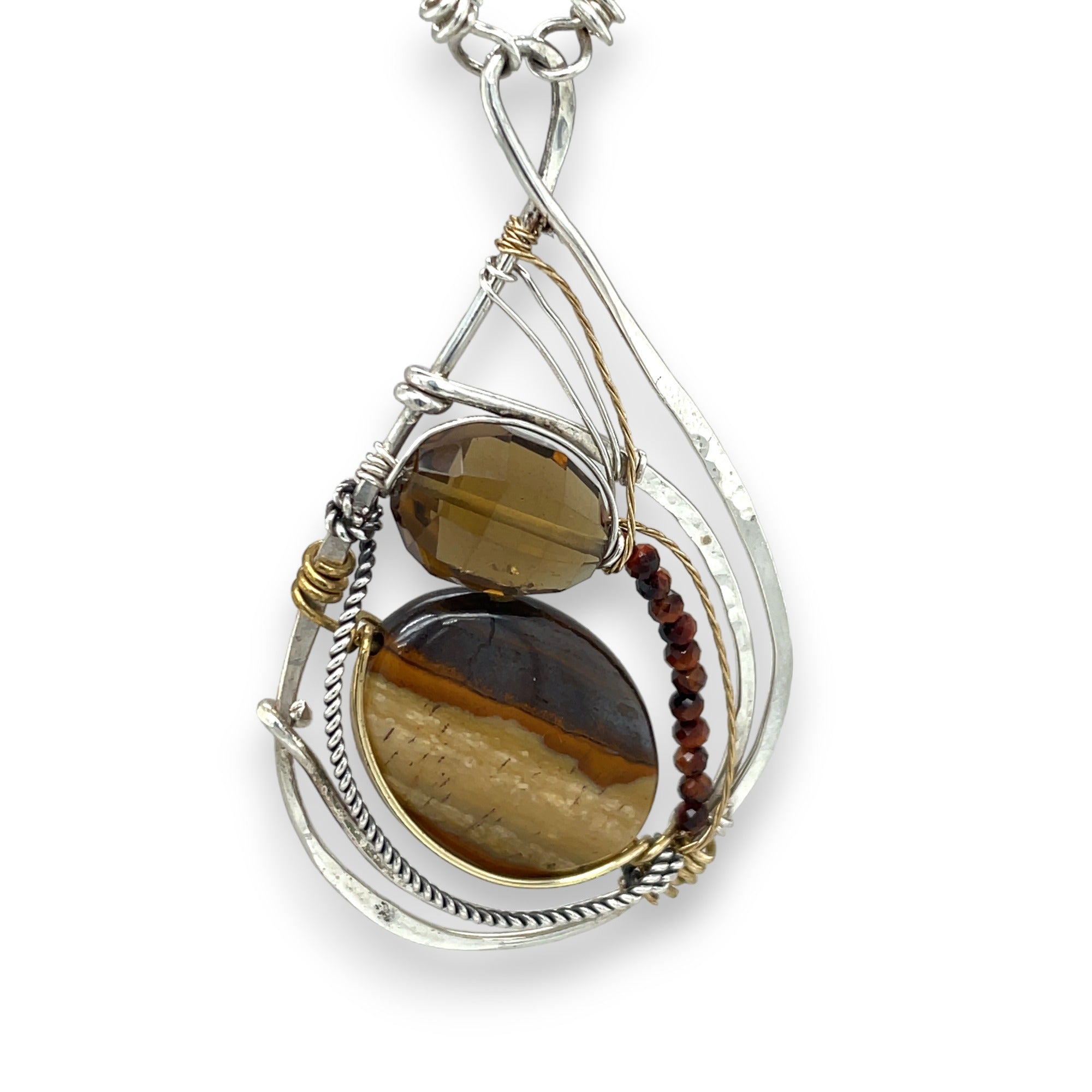 Petrified wood, smokey quartz, and tiger's eye gemstones fill a sterling silver pendant necklace with gold fill accents