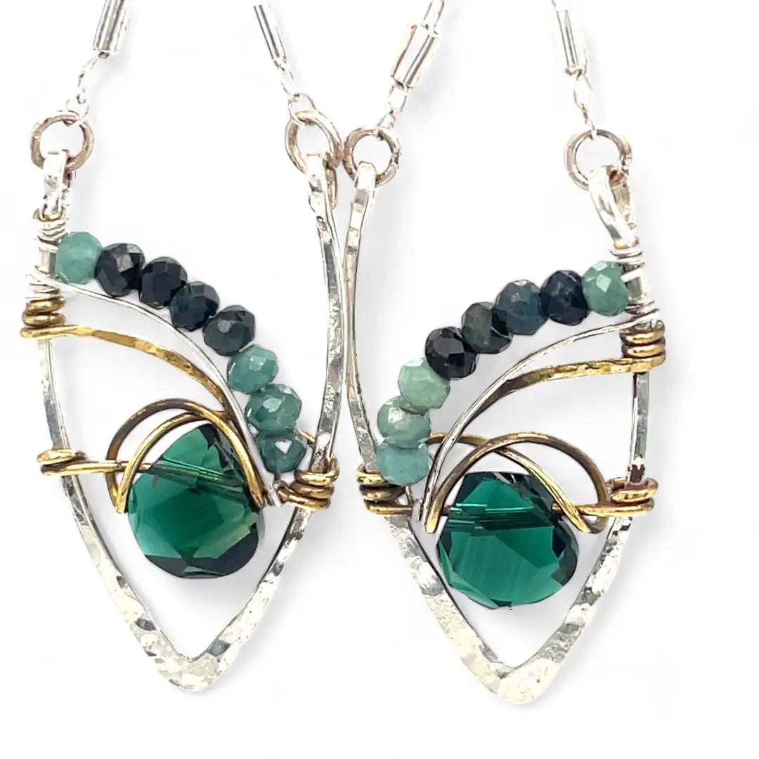 A pair of sterling silver leaf earrings with faceted green amethyst and blue tourmaline gemstones, wrapped in hand-formed hammered brass with sterling silver tube chain tops
