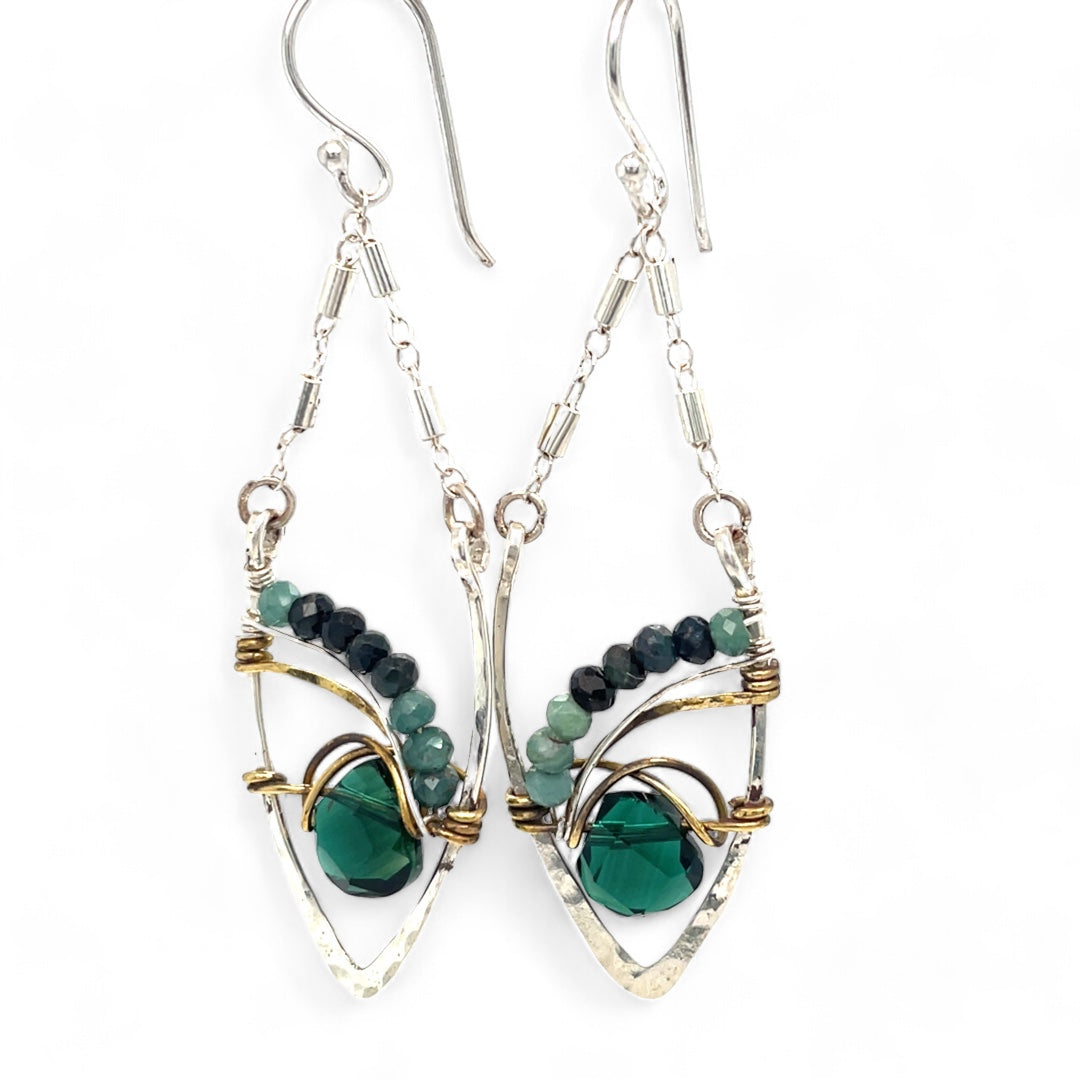A pair of sterling silver leaf earrings with faceted green amethyst and blue tourmaline gemstones, wrapped in hand-formed hammered brass with sterling silver tube chain tops