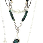 A sterling silver double chain necklace with adjuster, featuring dark green fresh water pearl, dark green amethyst drop, faceted blue tourmaline ombre gemstones, green amethyst, and oxidized sterling silver diamond cut links 