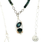A sterling silver double chain necklace with adjuster, featuring dark green fresh water pearl, dark green amethyst drop, faceted blue tourmaline ombre gemstones, green amethyst, and oxidized sterling silver diamond cut links 