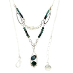 A sterling silver double chain necklace with adjuster, featuring dark green fresh water pearl, dark green amethyst drop, faceted blue tourmaline ombre gemstones, green amethyst, and oxidized sterling silver diamond cut links 