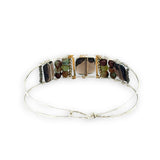 Smokey quartz tile center surrounded by pyrite, chrysoprase, and smokey quartz rectangle gemstones on a sterling silver cuff bracelet
