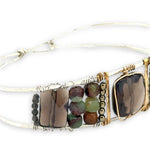 Smokey quartz tile center surrounded by pyrite, chrysoprase, and smokey quartz rectangle gemstones on a sterling silver cuff bracelet