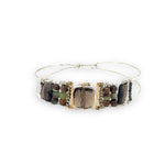 Smokey quartz tile center surrounded by pyrite, chrysoprase, and smokey quartz rectangle gemstones on a sterling silver cuff bracelet