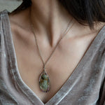 Sterling silver drop necklace with round faceted prehnite gemstone, accented with watermelon tourmaline. Oxidized sterling silver and gold-filled delicate double chain