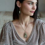 Sterling silver drop necklace with round faceted prehnite gemstone, accented with watermelon tourmaline. Oxidized sterling silver and gold-filled delicate double chain