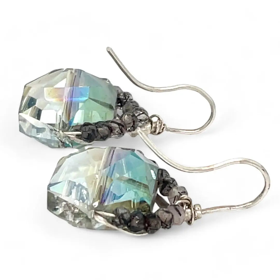 A pair of mini sparkly mint colored hexagon pcrystal earrings with handmade sterling silver tops and black tourmalinated faceted quartz gemstones, designed with built-in sterling silver hooks to wear like a post earring