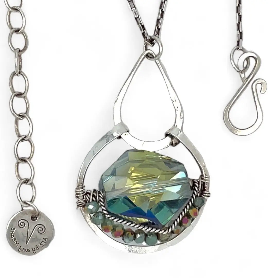 A sterling silver necklace with a box chain and an oval citrus crystal pendant, surrounded by smaller faceted crystals.