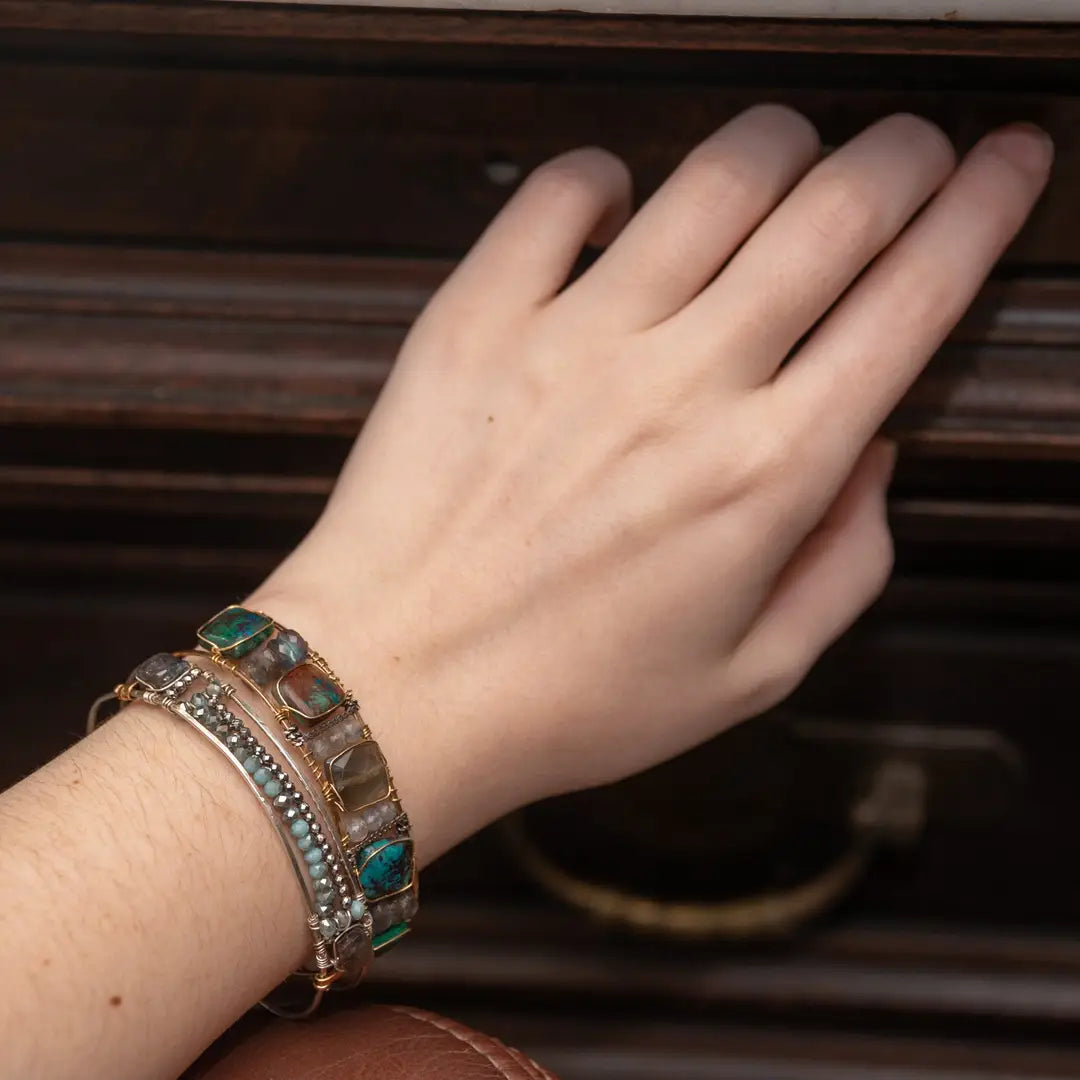 Chrysocolla and flashy labradorite tile gemstones are held within a brass cuff bracelet frame with oxidized sterling silver and gold filled wire accents