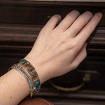 Chrysocolla and flashy labradorite tile gemstones are held within a brass cuff bracelet frame with oxidized sterling silver and gold filled wire accents