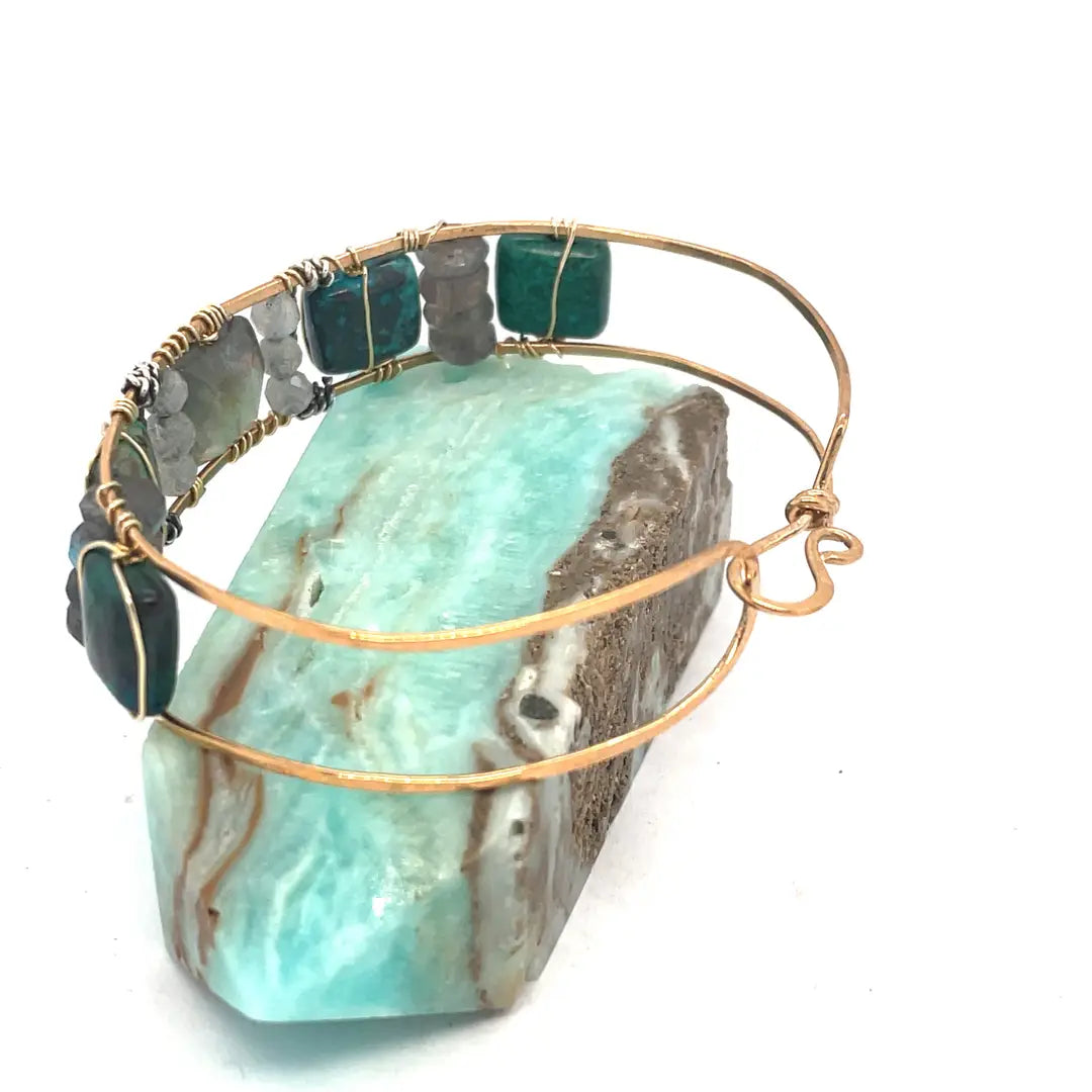Chrysocolla and flashy labradorite tile gemstones are held within a brass cuff bracelet frame with oxidized sterling silver and gold filled wire accents
