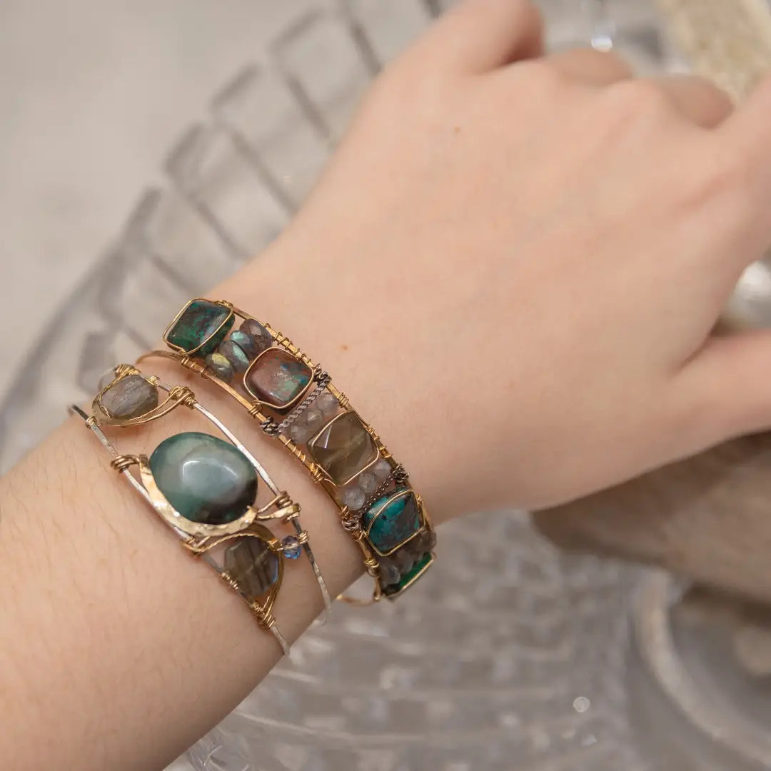 Chrysocolla and flashy labradorite tile gemstones are held within a brass cuff bracelet frame with oxidized sterling silver and gold filled wire accents