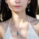 Sterling silver and bronze hammered ripples form an organic pendant filled with blue silver fresh water pearl, blue tourmaline, crystal. and mauve moonstone teardrop gemstone necklace