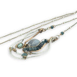 Sterling silver and bronze hammered ripples form an organic pendant filled with blue silver fresh water pearl, blue tourmaline, crystal. and mauve moonstone teardrop gemstone necklace