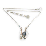 Sterling silver and bronze hammered ripples form an organic pendant filled with blue silver fresh water pearl, blue tourmaline, crystal. and mauve moonstone teardrop gemstone necklace