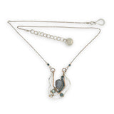 Sterling silver and bronze hammered ripples form an organic pendant filled with blue silver fresh water pearl, blue tourmaline, crystal. and mauve moonstone teardrop gemstone necklace