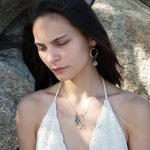 Sterling silver and bronze hammered ripples form an organic pendant filled with blue silver fresh water pearl, blue tourmaline, crystal. and mauve moonstone teardrop gemstone necklace