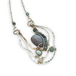 Sterling silver and bronze hammered ripples form an organic pendant filled with blue silver fresh water pearl, blue tourmaline, crystal. and mauve moonstone teardrop gemstone necklace