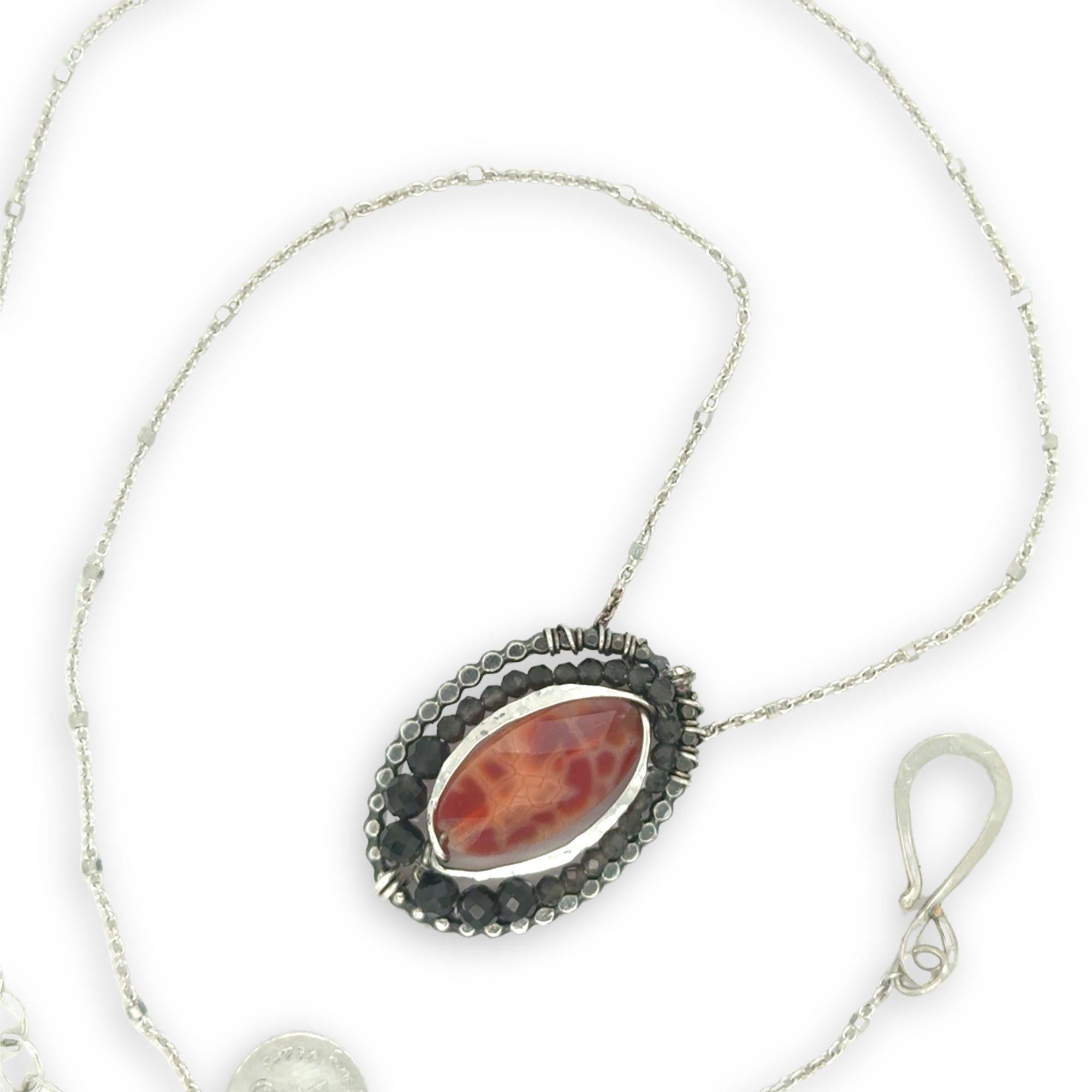 darkened oval hammered sterling silver dot pendant with green obsidian and a red fire agate oval gemstone on delicate sterling silver chain necklace
