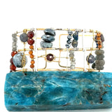 Bronze and sterling silver wide bracelet with labradorite, hessonite garnet, iolite, pyrite, and blue opal gemstones, with  twisted brass accents