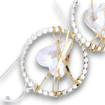 Sterling silver dot hoops with clear faceted heart shaped crystals held in wraps of hammered 14k gold filled wire