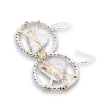 Sterling silver dot hoops with clear faceted heart shaped crystals held in wraps of hammered 14k gold filled wire