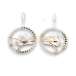 Sterling silver dot hoops with clear faceted heart shaped crystals held in wraps of hammered 14k gold filled wire