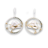 Sterling silver dot hoops with clear faceted heart shaped crystals held in wraps of hammered 14k gold filled wire