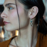 A pair of sterling silver chandelier earrings with brown fresh water pearl dangles and a central cat's eye faceted gemstone.