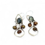 A pair of sterling silver chandelier earrings with brown fresh water pearl dangles and a central cat's eye faceted gemstone.