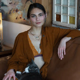 A pair of sterling silver chandelier earrings with brown fresh water pearl dangles and a central cat's eye faceted gemstone.