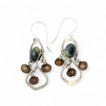 A pair of sterling silver chandelier earrings with brown fresh water pearl dangles and a central cat's eye faceted gemstone.