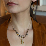 Green yellow jade long diamond hangs from gold filled box chain, with a layer of cat's eye gemstones, and a layer of oxidized sterling silver chain necklace