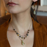 Green yellow jade long diamond hangs from gold filled box chain, with a layer of cat's eye gemstones, and a layer of oxidized sterling silver chain necklace